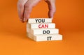 You can do it symbol. Concept word You can do it on beautiful wooden block. Beautiful orange table orange background. Businessman Royalty Free Stock Photo