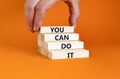 You can do it symbol. Concept word You can do it on beautiful wooden block. Beautiful orange table orange background. Businessman Royalty Free Stock Photo
