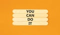 You can do it symbol. Concept word You can do it on beautiful wooden stick. Beautiful orange table orange background. Business Royalty Free Stock Photo