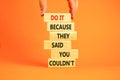 You can do it symbol. Concept words Do it because they said you could not on wooden block. Beautiful orange table background. Royalty Free Stock Photo