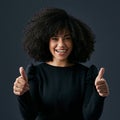 You can do this. a young businesswoman giving the thumbs up against a studio background. Royalty Free Stock Photo