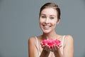 You can have beautifully soft skin too. Studio portrait of an attractive young woman holding a handful of pink petals