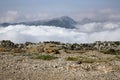 Mountain scenery clouds beneath you small rock stone and asphalt old road. Lebanon, Jbeil.