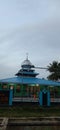 You can see a mosque at the other end with a high dome under the sky that is starting to dusk