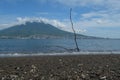 You can see a photo of Mount GAMALAMA on the island of Ternate, Indonesia during the day on the beach