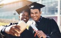 You can steer yourself in any direction you choose. two students taking a selfie on graduation day.