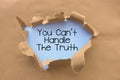 You can`t handle the truth saying behind torn brown paper or cardboard