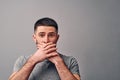 You canÃ¢â¬â¢t talk about this. Portrait of a afraid handsome man who closes his mouth with hands. The concept of prohibition, fear, Royalty Free Stock Photo