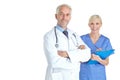 You can trust them with your life. Portrait of a mature male doctor standing beside a female colleague holding a chart. Royalty Free Stock Photo