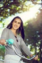 You cant be sad while riding a bicycle. Portrait of an attractive young woman riding her bicycle outside. Royalty Free Stock Photo