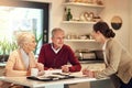 Because you cant enjoy the golden age without proper savings. a senior couple getting advice from their financial Royalty Free Stock Photo