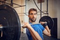 You cant go wrong with strong. a handsome young man lifting weights while working out in the gym. Royalty Free Stock Photo