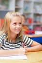 You cant put a price on a first-rate education. Cute young primary school girl paying close attention and taking notes