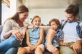 You cant put a price on quality time. a happy family of four relaxing together on the sofa at home. Royalty Free Stock Photo