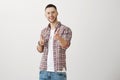 You caught me with your charm. Indoor shot of positive attractive young man with bristle, pointing at camera with index Royalty Free Stock Photo