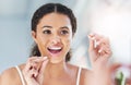 When you clean, do it properly. an attractive young woman flossing her teeth in the bathroom at home. Royalty Free Stock Photo