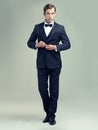 You clean up nice. A full length studio portrait of a dapper young man wearing a vintage suit and bow tie.