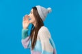 Are you coming or not. Happy and carefree outgoing smiling brunette girl in trendy winter sweater, hat, turn left and