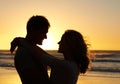 You complete me. Romantic shot of a couple gazing into each others eyes on the beach at sunset. Royalty Free Stock Photo