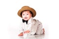 Funny smiling baby in in suit, retro hat and a bow-tie, crawling over white background Royalty Free Stock Photo