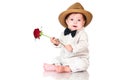 Smiling one old year boy in retro, bow-tie hat and with red rose sitting on white background. Royalty Free Stock Photo