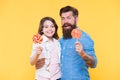 For you. Daughter and father eat sweet candies. bearded hipster man is good dad. daddy and small girl kid love colorful