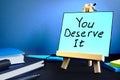 You deserve it written text on table. Motivation and inspiration