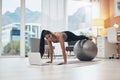 You dont need the gym when you have the internet. a woman working out in her living room with her laptop in front of her Royalty Free Stock Photo