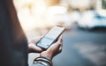 You dont need much to stay connected. Closeup shot of a businesswoman using a cellphone in the city. Royalty Free Stock Photo