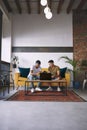 You dont need an office space to run a successful business. two men using a laptop and a digital tablet while having Royalty Free Stock Photo