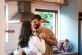 You dont need a reason to be romantic. a happy young couple dancing in the kitchen at home. Royalty Free Stock Photo