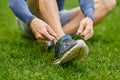 You dont wanna trip over your laces. High angle shot of an unrecognizable male runner tying his shoelaces during an