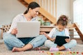 Are you enjoying that game. a mother and her little daughter using digital devices at home. Royalty Free Stock Photo