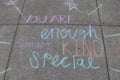 `You are enough smart special kind` rainbow sidewalk chalk art