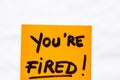 You are fired handwriting text close up isolated on yellow paper with copy space Royalty Free Stock Photo