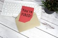 You are fired text on red note inside brown envelope. Royalty Free Stock Photo