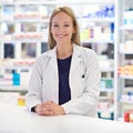 You friendly neighborhood pharmacist. Portrait of an attractive pharmacist standing at the prescription counter.