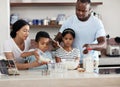 You gotta make it then bake it. a young family baking together in the kitchen at home.