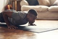 You have to be fearless in order to achieve results. a sporty young man doing push up exercises at home.