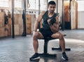 You have to break through your limit. a muscular young man exercising with a dumbbell in a gym. Royalty Free Stock Photo