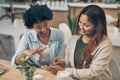 You have to help me decide on a outfit. Shot of two friends looking at something on a cellphone while sitting together Royalty Free Stock Photo