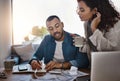 You have to save and spend wisely. a young couple planning their budget together at home.