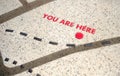 You are Here icon on map on the ground pavement