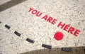 You are Here icon on map on the ground pavement Royalty Free Stock Photo