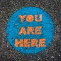 You Are Here, Sign Painted on Pavement Royalty Free Stock Photo