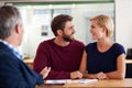 You here That. Young couple discussing investment plans with a financial advisor. Royalty Free Stock Photo