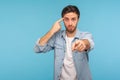 You are idiot! Portrait of man in shirt showing stupid gesture and pointing to camera, blaming for insane plan Royalty Free Stock Photo