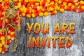 You are invited message with candy corn and a skeleton