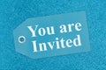 You are invited message on teal gift tag