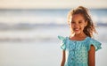 You just cant frown while youre at the beach. an adorable little girl having fun at the beach.